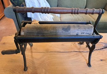 Cast Iron Newspaper Roller.