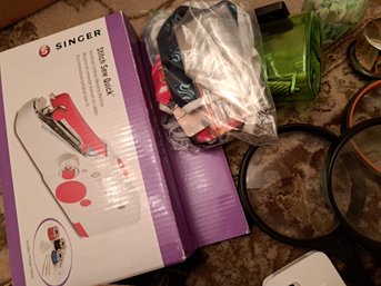 Office Supplies, Hand Held Sewing Machine, Apple Earbuds, Kids Games And Toys, Magnifying Glass.