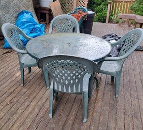 Outdoor Glass Table With Four Plastic Chairs
