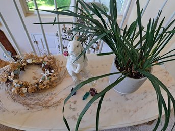 Large Potted Plant, Wreath, Glass Rabbit Figurines.