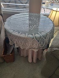 Tall Side Table With Table Cloths And Glass Topper.
