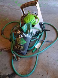 Two Garden Hoses, Wall Mount For Hose, Watering Can, Hand Shovel, And Mose Out.