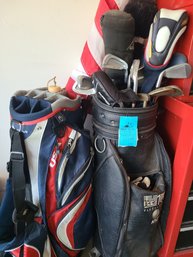 Golf Clubs, Balls, Tees, Two Golf Bags, And Two Flags With Poles