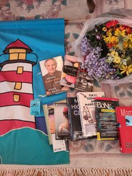Various Books, Lighthouse Flag And Faux Flowers.