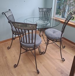 R3. Round Glass Top Dining Room Table With Four Chair And Cushions.