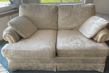 White Loveseat With Two Pillows