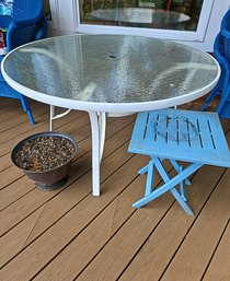 R00 Glass Outdoor Table, Flower Pot, And Small Blue Plastic Side Table