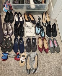 Two Containers Full Of Shoes And A Laundry Basket With More Shoes