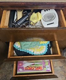 R3 Three Drawers Full Of Kitchen Ware Including Utensils, Oven Mitts And Towels, Bread Cutter, Grater, Chopper