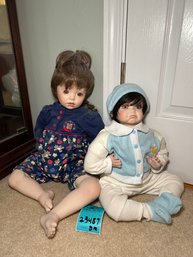 R7 Two Baby Porcelain Dolls Measuring 12 In Tall And 15 In Tall Sitting Down