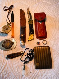 Rm5 Collection Of Knives, Belt Buckle, Case, Compass, Size 8 Ring, Pendant, And Pin