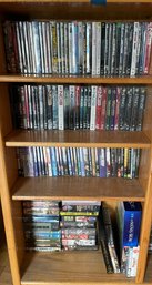 Four Shelves Of DVDs Of Various Themes And Titles