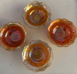 Four Small Carnival Glass Dishes In Various Shades Of Orange