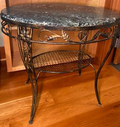 A4 Side Table With What Appears To Be A Marble Top And Iron Legs