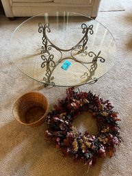 Glass Topped Wrought Iron Base Round Coffee Table.  Wicker Trash Basket And Decorative Wreath