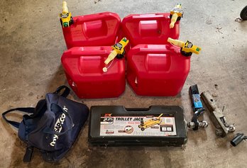R00 New Trolley Jack, Two Trailer Hitches, Four Gas Cans And A Bag