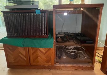 R10 Wooden Entertainment Cabinet, Assorted Cords, Assorted Electronic Equipment, Headphones, Alarm Clock