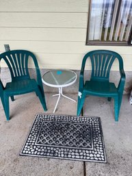 Outdoor Plastic Chairs. Small Table And Door Mat