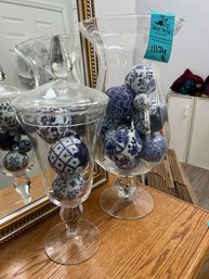 Glass Vase 20in Tall 9.5in Wide And Glass Lidded Jar 19in Tall Both Filled With Porcelain Blue And White Balls