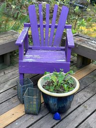 R00 Purple Deck Chair With A Potted Plant And Two Decorative Lanterns That Were Repurposed For Potting