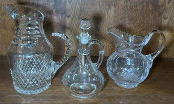 Two Crystal Pitchers And One Decanter With Stopper