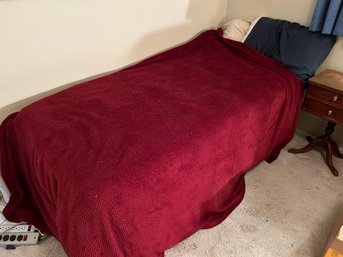 R6 Twin Size Bed With Wheels, Red Blankets, Blue Bed Sheets, Two Pillows