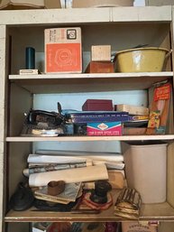 Three Shelves Of Items To Include Rolled Up Art Prints, An Iron, A Y-line Scale, Jewelry Box