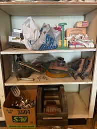 Three Shelves Of Items Including Ice Skates, Ink Wells, Garden Rocks, Utensils , And Wine Storage Unit
