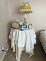 R7 Round Side Table With Linens, Small Mirror, Clock, Candle In Holder, Tissue Cover And Decorative Lamp