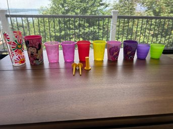 R3 Heart Cup, Minnie Mouse Cup, Four Colorful Plastic Cups, Two Sesame Street Cups, Two Smaller Colorful Cups