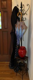 R1 Entryway Decor To Include A Coat Rack With Some Raincoats And An Umbrella, An Iron Mouse Doorstop, A Small