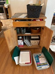 Small Cabinet With Office Supplies And Two American Flags