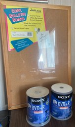 RM3 New Cork Bulletin Board With A Natural Wood Frame And Two Sony DVDR Blank Discs