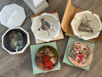 Two Norman Rockwell Christmas Plate, Two Avon Collectibles Christmas Plates, And One Hamilton Lion Plate