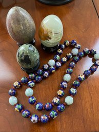 Three Crystal Eggs And A String Of Enamel Beads