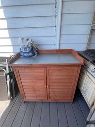 Outdoor Cabinet And Used Bag Of Charcoal