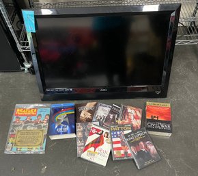 Vizio Television With DVDS, Blu-rays, And A Beatles Film Festival Magazine