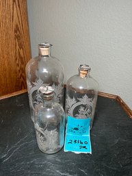 R1 Set Of Three Glass Decorative Glass Bottles With Floral Designs  See Photos For Measurements