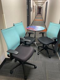 Three Adjustable Blue Chairs And An Office Table