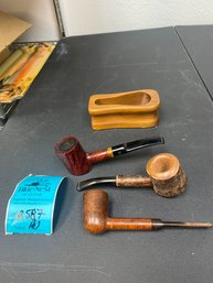 Three Eatate Pipes And A Wood Pipe Rest