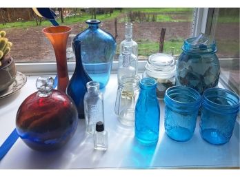 R8 Assortment Of Different Colored Glass Jars And Vases