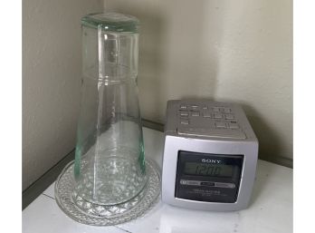 R9 Sony Alarm Clock Radio And A Glass Container