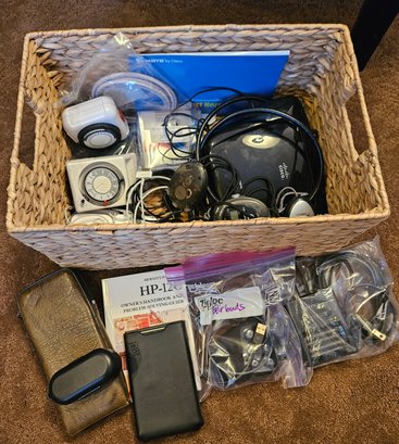Basket Of Earphones, Cisco Router, And HP Calculator