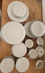 Full Set Of Silver And White Plates