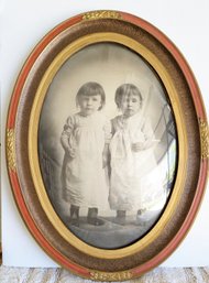 Vintage Oval Shaped Frame Portrait Of Two Girls.