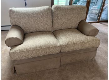 Tan Loveseat With Leaf Design Cushions