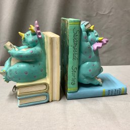 Dinosaur Musical BookEnds Featuring 2 Hefty Spotted Colorful Dinosaurs Reading Books On Top Of Books