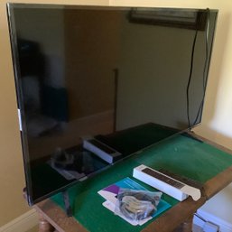 43 Inch Hisense Roku LED LCD TV,  Manufactured In 2019 On Table Stand