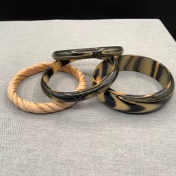 4 Bangles, 3 Matching Black And Tan, One Tan And Gold Weave