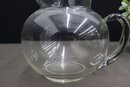 2 Glass Pitchers - A Medium And A Large Round Belly Pitcher With Handle Spout Ice Lip